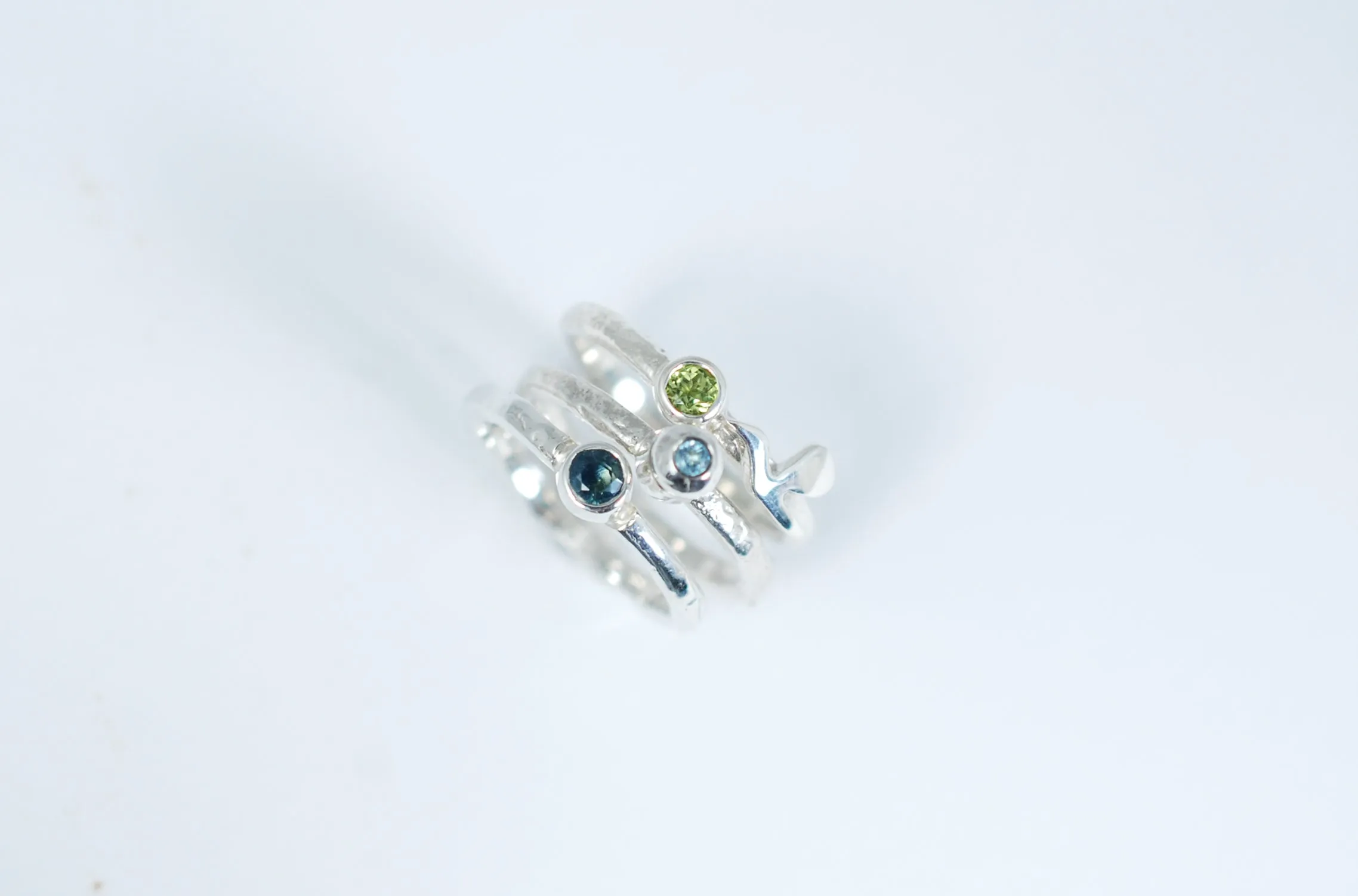 Silver stacking ring with blue Topaz.
