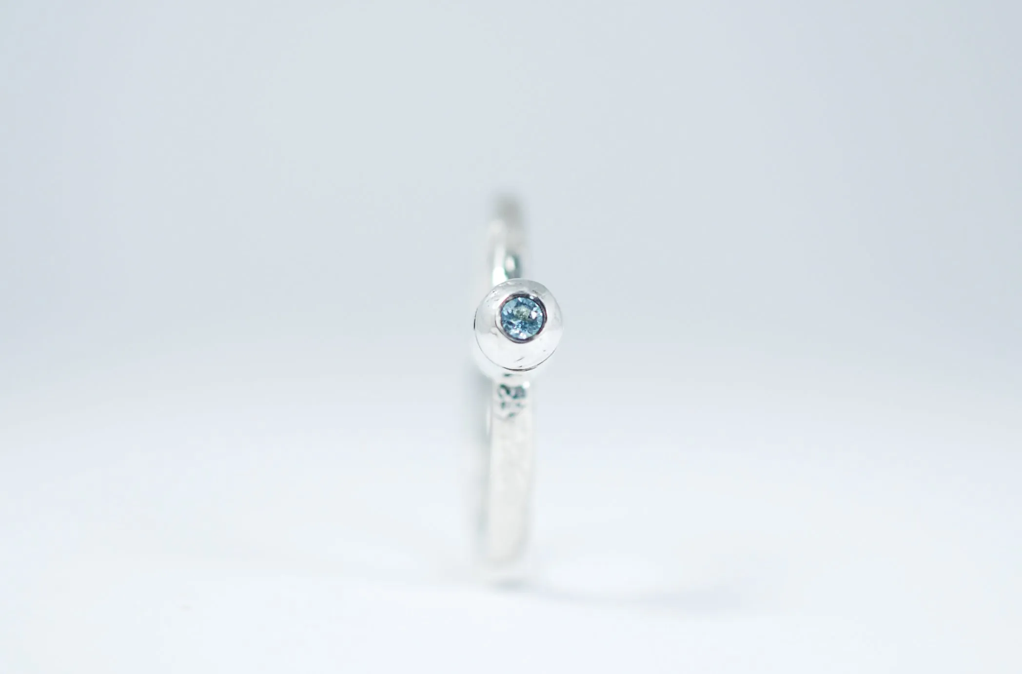Silver stacking ring with blue Topaz.